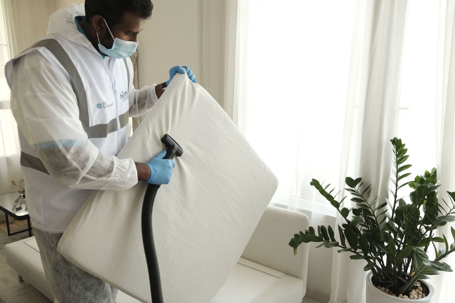 Technician cleaning a mattress